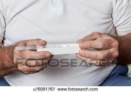 Stock Photo - Man holdin a pillbox. Fotosearch