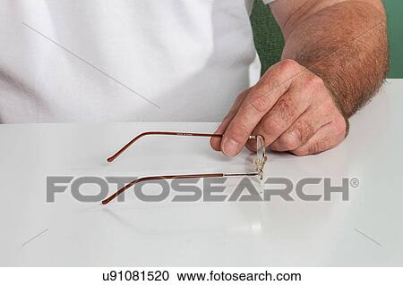 Man holding a glasses View Large Photo Image Stock Image - Man holding a glasses. Fotosearch