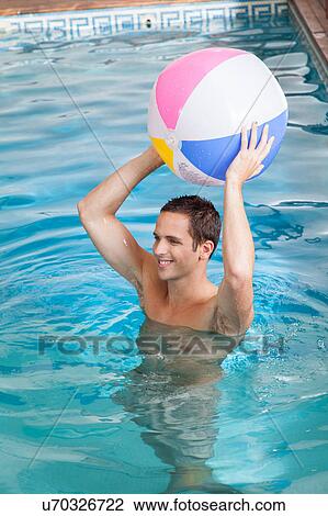 Man holding a inflatable ball View Large Photo Image Stock Image - Man holding a inflatable ball. Fotosearch