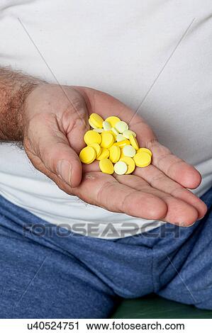 Man holding a lot of pills View Large Photo Image Stock Image - Man holding a lot of pills. Fotosearch