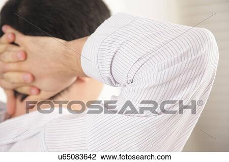 Stock Image - Man holding his head. Fotosearch