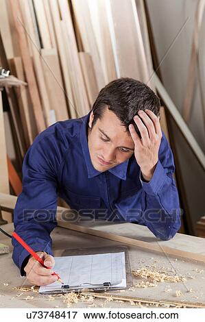 Stock Photo - Man holding his head, thinking. Fotosearch