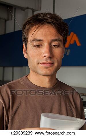Stock Photo - Man holding soap powder. Fotosearch