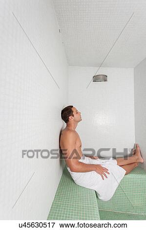 Stock Photo - Man laid in the sauna. Fotosearch