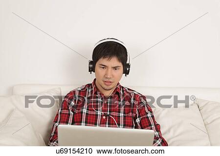 Stock Image - Man listening to music. Fotosearch