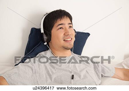 Man listening to music View Large Photo Image Stock Photo - Man listening to music. Fotosearch