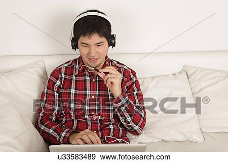 Stock Photo - Man listening to music. Fotosearch