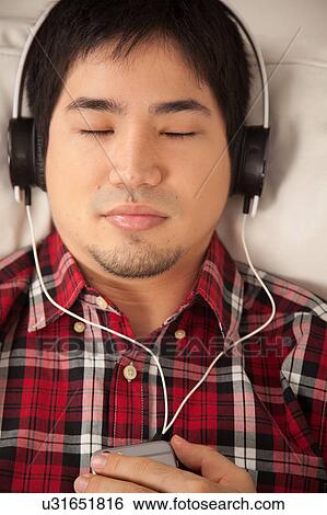 Man listening to music View Large Photo Image Stock Photograph - Man listening to music. Fotosearch