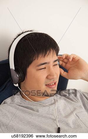Man listening to music View Large Photo Image Stock Photograph - Man listening to music. Fotosearch