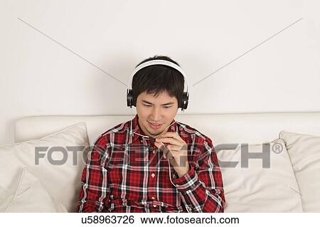 Man listening to music View Large Photo Image Stock Photograph - Man listening to music. Fotosearch