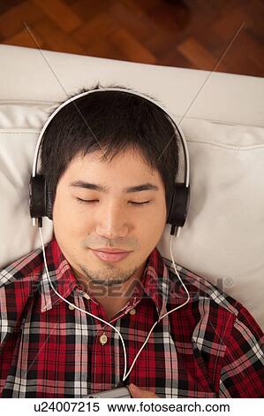 Man listening to music View Large Photo Image Stock Photography - Man listening to music. Fotosearch