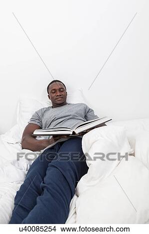 Man looking at book View Large Photo Image Picture - Man looking at book. Fotosearch