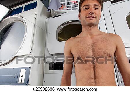man looking at camera in the laundry View Large Photo Image Stock Photograph - man looking at camera in the laundry. Fotosearch