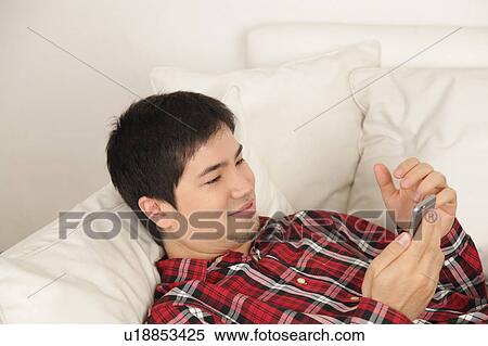 Stock Photography - Man looking at phone. Fotosearch