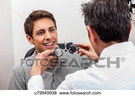 Man looking at the glasses View Large Photo Image Stock Photo - Man looking at the glasses. Fotosearch