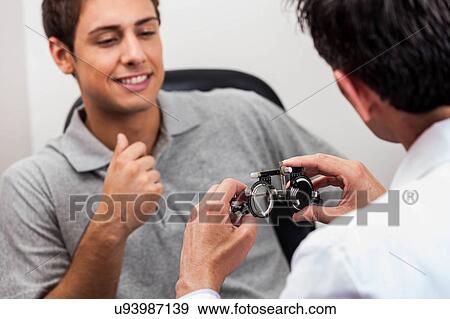Man looking at the glasses View Large Photo Image Stock Photo - Man looking at the glasses. Fotosearch
