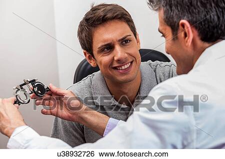 Stock Photograph - Man looking at the glasses. Fotosearch