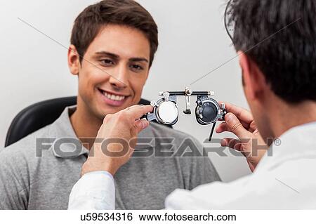 Man looking at the glasses View Large Photo Image Stock Photograph - Man looking at the glasses. Fotosearch