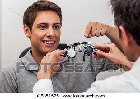 Man looking at the glasses View Large Photo Image Stock Photography - Man looking at the glasses. Fotosearch