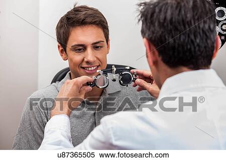 Man looking at the glasses View Large Photo Image Stock Photography - Man looking at the glasses. Fotosearch