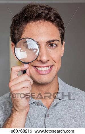 Man looking through loupe View Large Photo Image Stock Photography - Man looking through loupe. Fotosearch