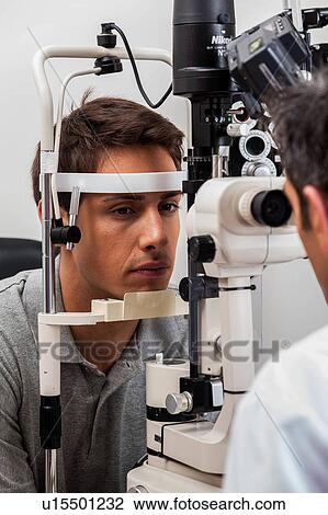 Man looking through the keratometer View Large Photo Image Stock Image - Man looking through the keratometer. Fotosearch