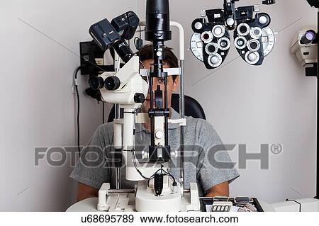 Man looking through the keratometer View Large Photo Image Stock Photo - Man looking through the keratometer. Fotosearch