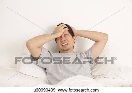 Man lying with headache View Large Photo Image Stock Photo - Man lying with headache. Fotosearch