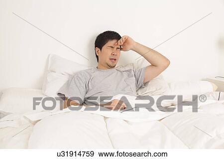 Man lying with headache View Large Photo Image Stock Photo - Man lying with headache. Fotosearch