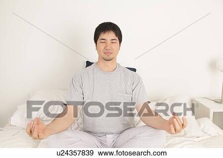 Stock Photo - Man meditating. Fotosearch