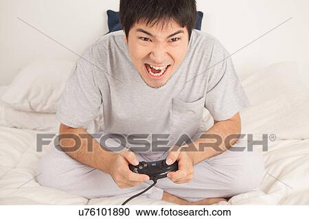 Man playing video games and shouting View Large Photo Image Stock Image - Man playing video games and shouting. Fotosearch