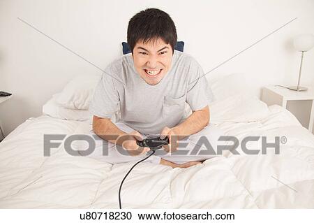 Man playing video games and shouting View Large Photo Image Stock Image - Man playing video games and shouting. Fotosearch