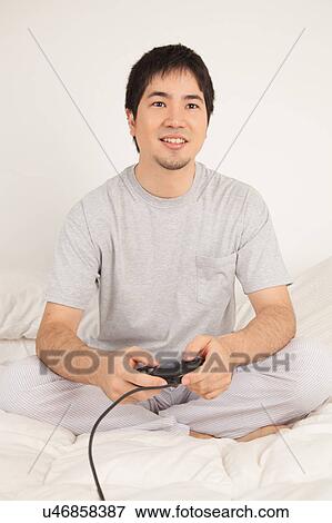 Stock Photo - Man playing video games. Fotosearch