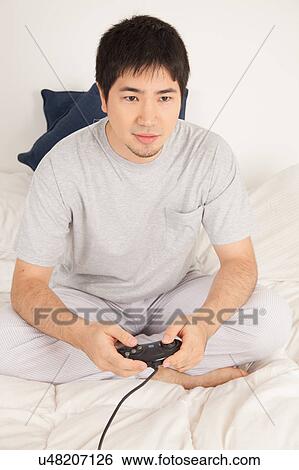 Stock Photograph - Man playing video games. Fotosearch