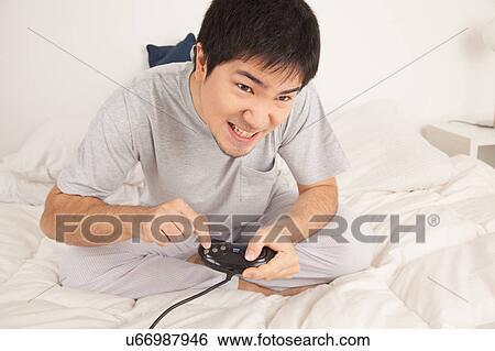 Stock Photograph - Man playing video games. Fotosearch