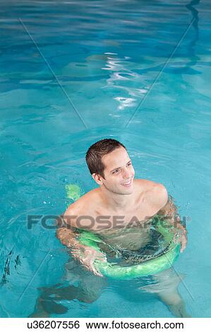 Man playing with float View Large Photo Image Stock Photograph - Man playing with float. Fotosearch