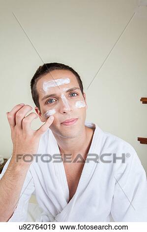 Man putting on face cream View Large Photo Image Stock Photo - Man putting on face cream. Fotosearch
