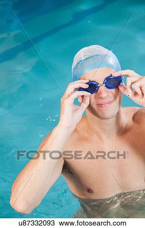 Man putting on goggles View Large Photo Image Stock Image - Man putting on goggles. Fotosearch