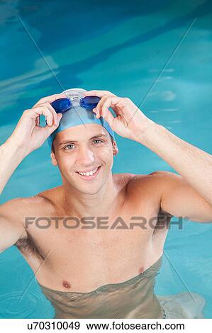 Man putting on goggles View Large Photo Image Stock Photo - Man putting on goggles. Fotosearch