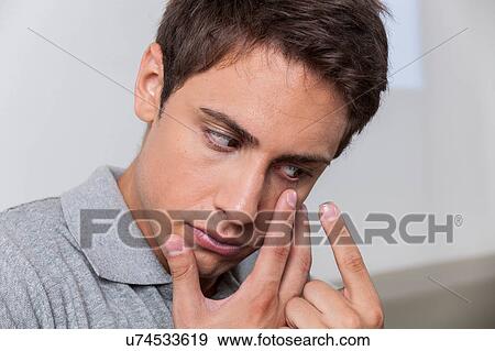 Man putting the contact lenses View Large Photo Image Stock Photo - Man putting the contact lenses. Fotosearch