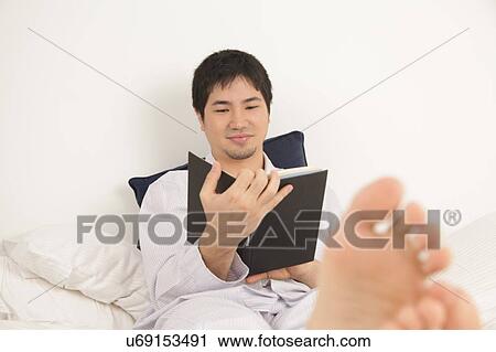 Man reading a book View Large Photo Image Stock Image - Man reading a book. Fotosearch