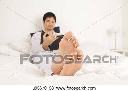 Stock Photo - Man reading a book. Fotosearch