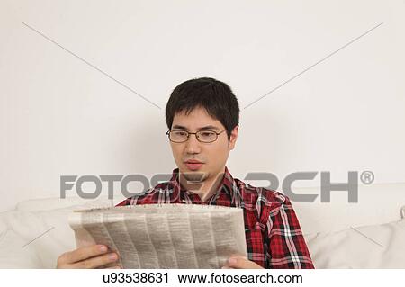Stock Image - Man reading the newspaper. Fotosearch