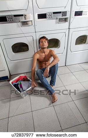 Man resting in the laundry View Large Photo Image Stock Photo - Man resting in the laundry. Fotosearch
