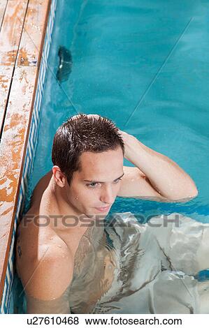 Stock Photo - Man resting in the pool. Fotosearch