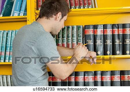 Man searching a book View Large Photo Image Stock Image - Man searching a book. Fotosearch