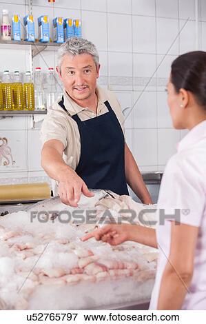 Man selling fish View Large Photo Image Stock Photo - Man selling fish. Fotosearch