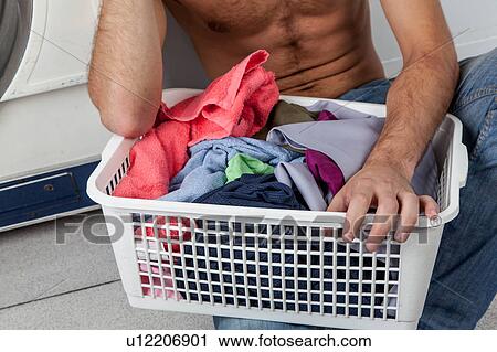 Man sitting on the floor in the laundry View Large Photo Image Stock Image - Man sitting on the floor in the laundry. Fotosearch
