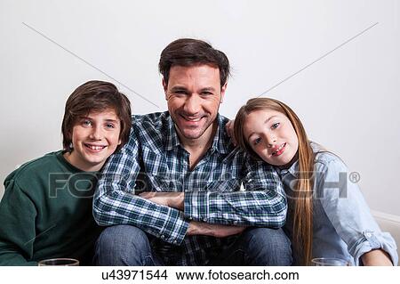 Man sitting with your two sons View Large Photo Image Picture - Man sitting with your two sons. Fotosearch