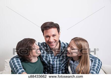 Man sitting with your two sons View Large Photo Image Stock Image - Man sitting with your two sons. Fotosearch